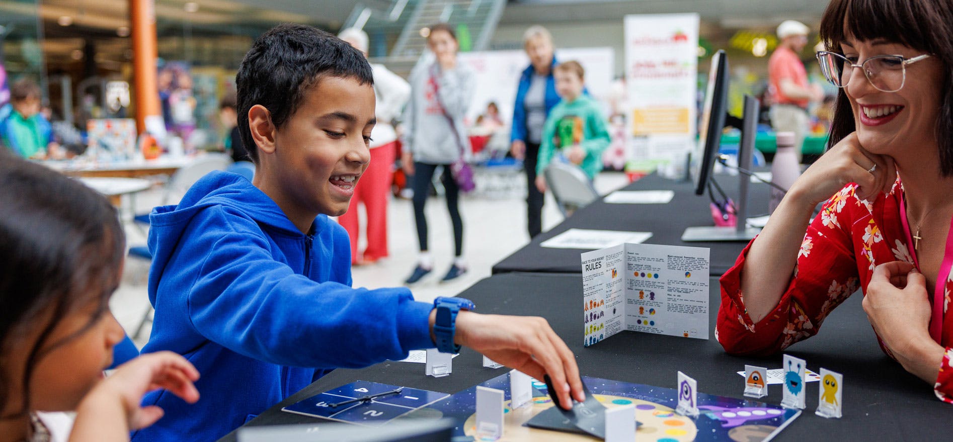 A boy smiles while playing an alien inspired boardgame
