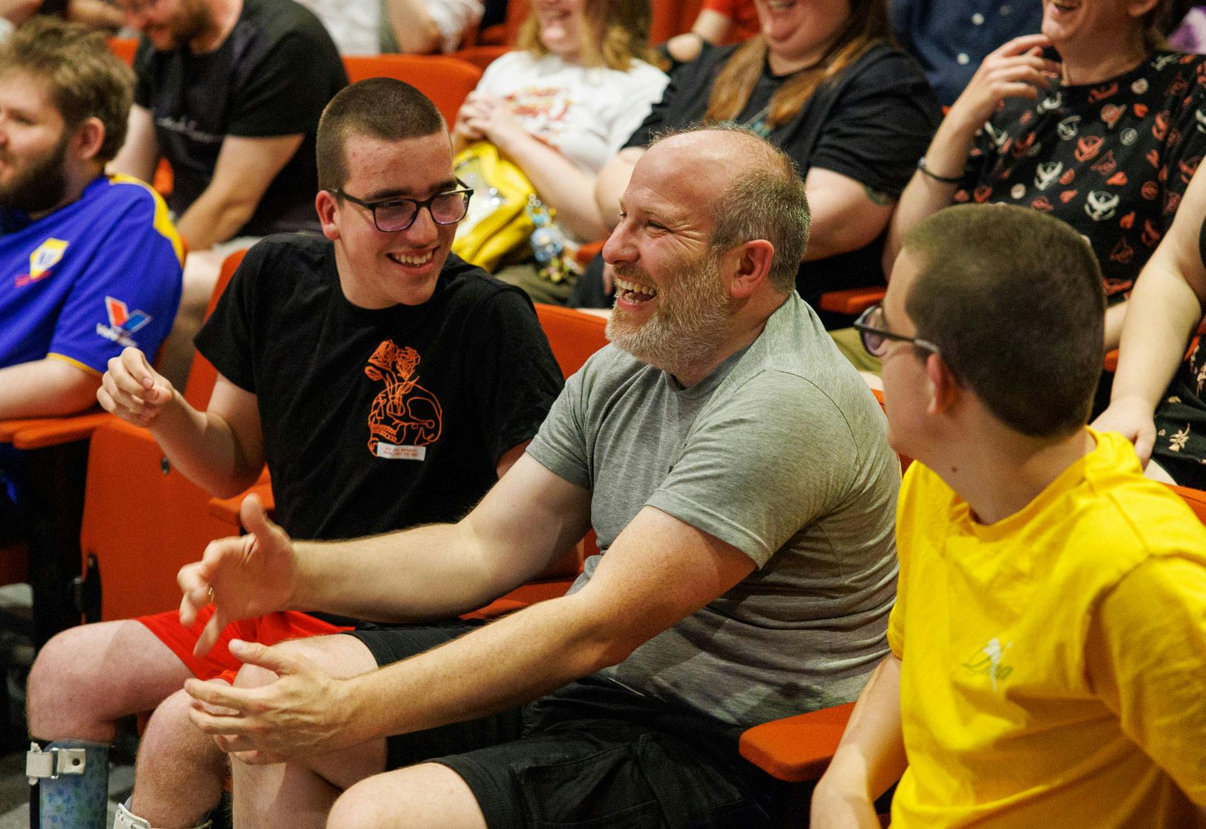 Audience members laugh at a speakers joke
