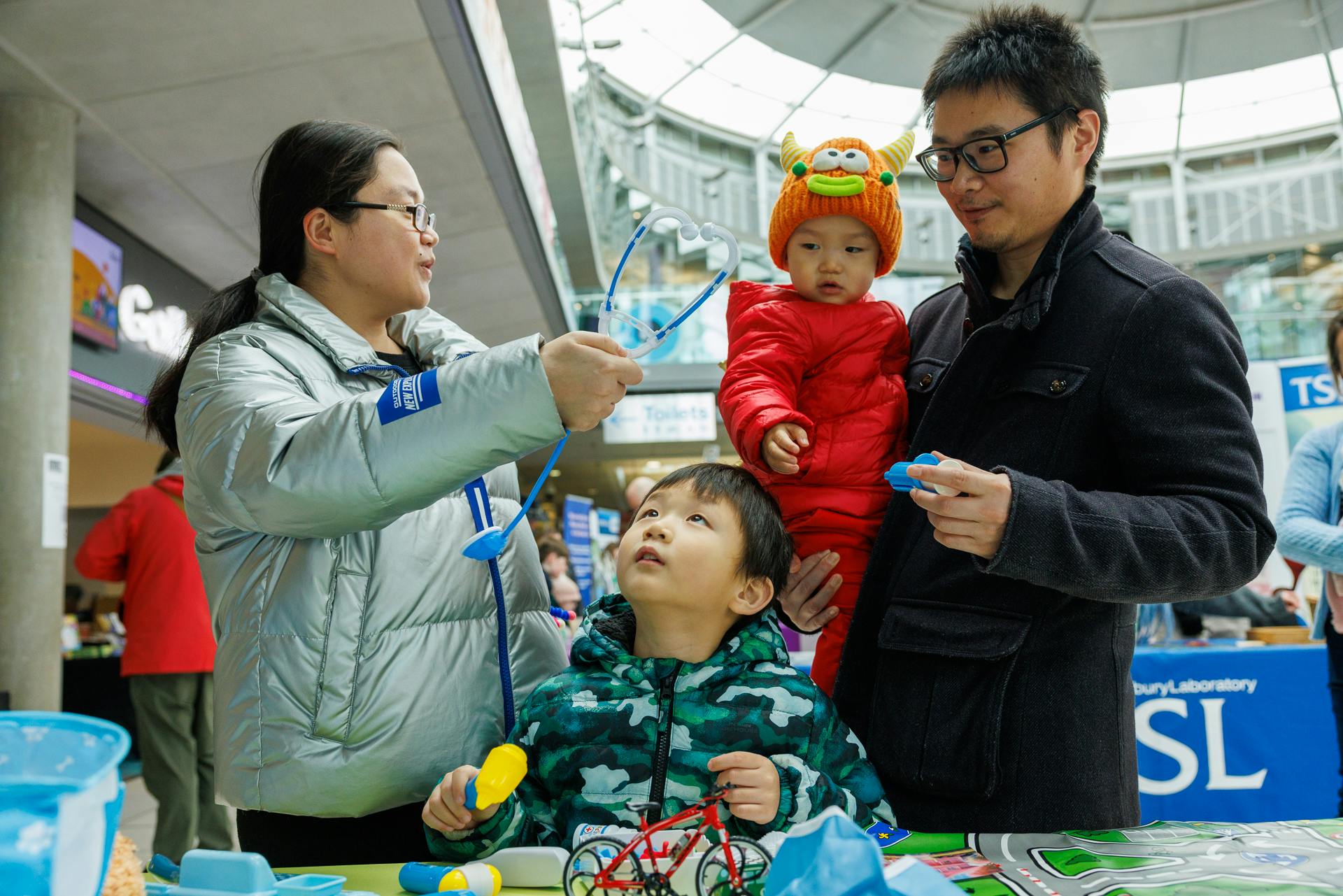 A family of four take part in a veterinary activity together in The Explorium