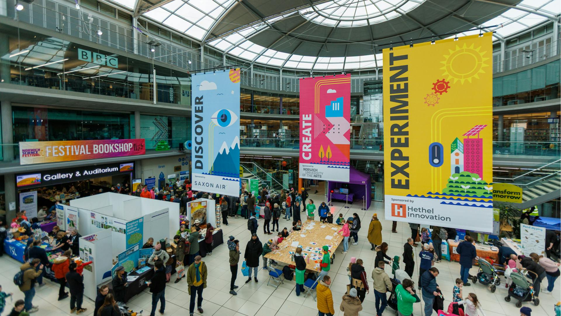 A wide shot of The Forum's Atrium, taken from the balcony and showing visitors in The Explorium during Norwich Science Festival 2025.