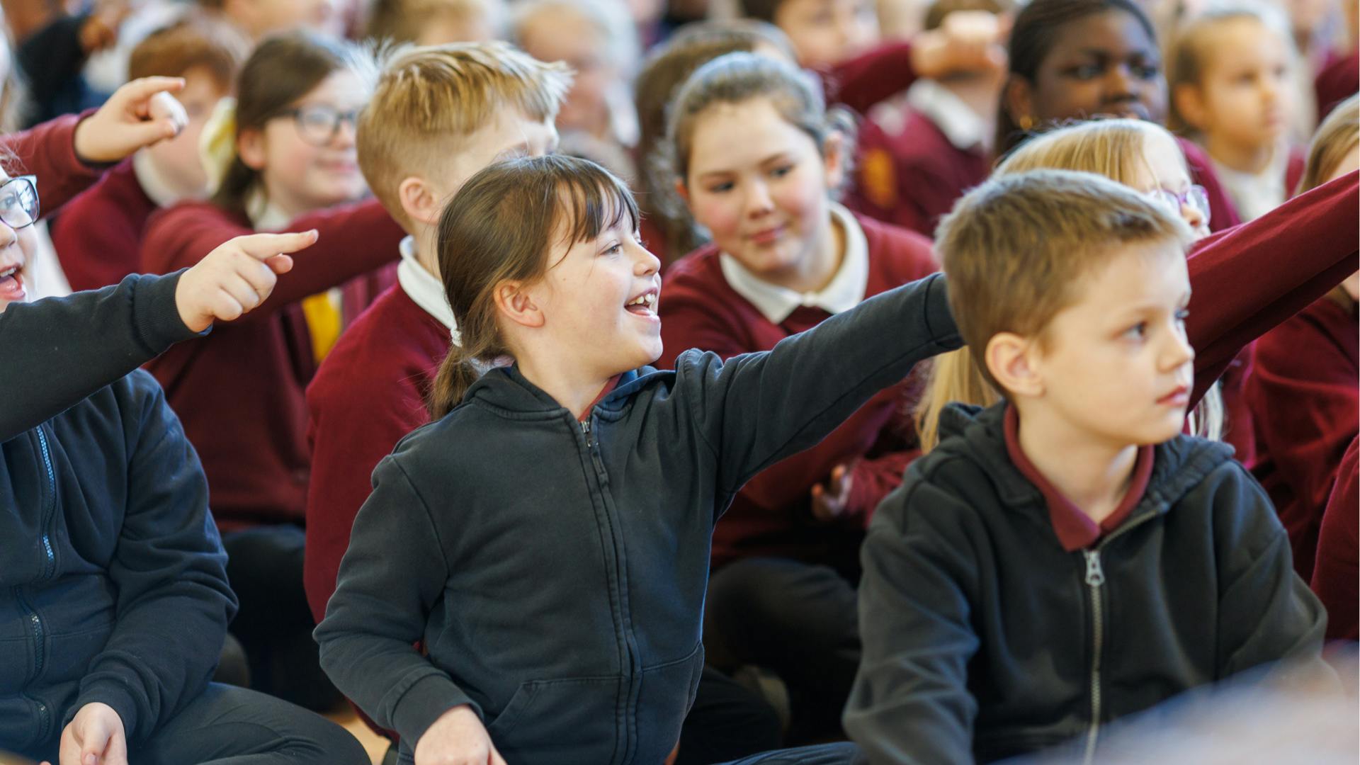 A group of school pupils enjoy a Norwich Science Festival show at their school.