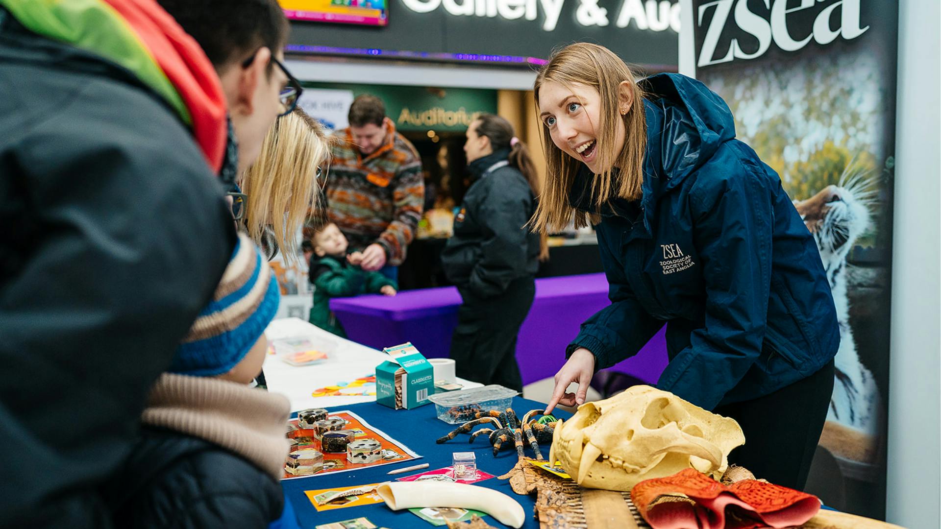 A member of staff from ZSEA speaks to visitors at Norwich Science Festival 2025