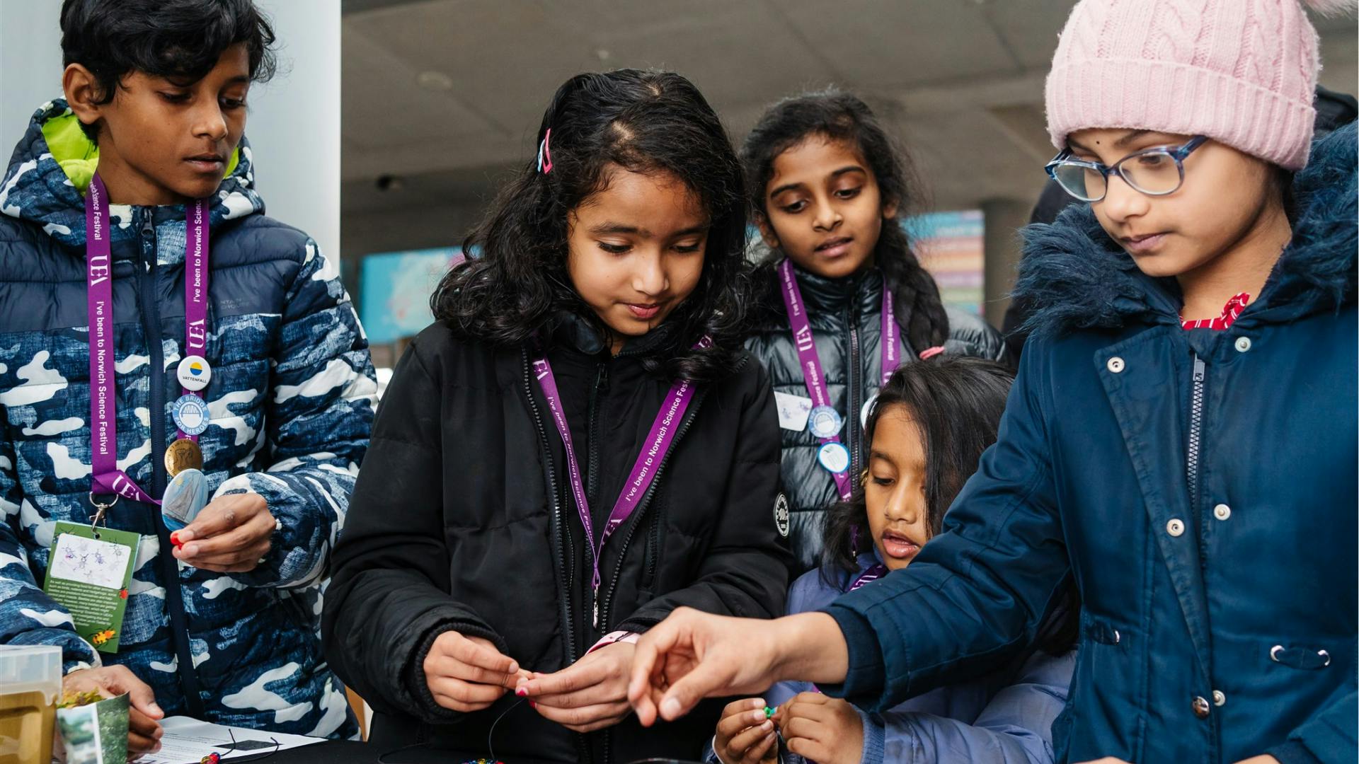 light-up-the-city-web-header.png A group of children are busy working on a science project around a table.