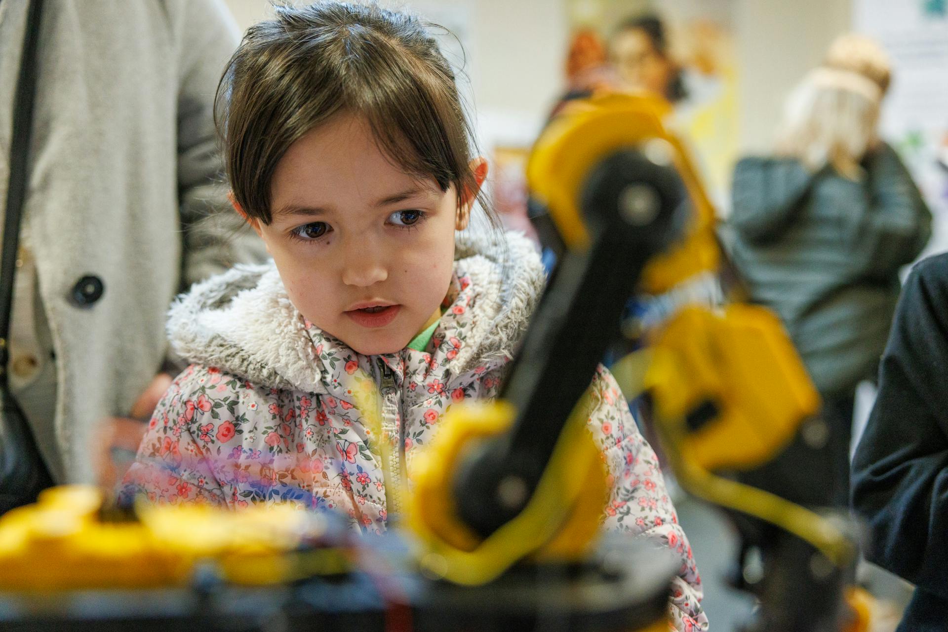 A child watches a robot in action at Norwich Science Festival 2024