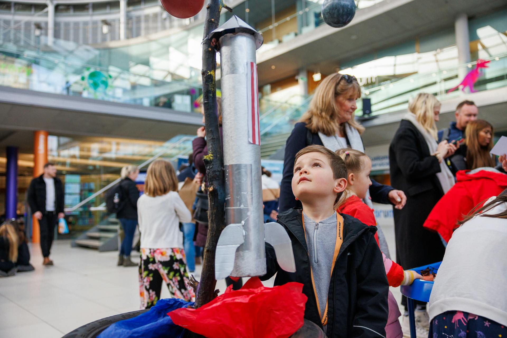 A child looks up at a rocket installation at Norwich Science Festival 2024