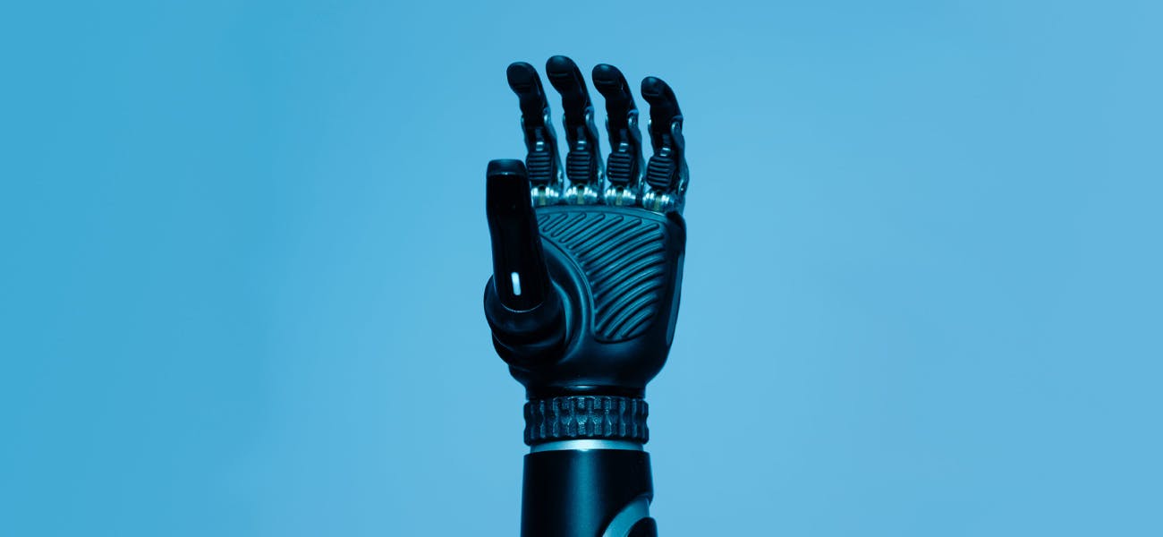 A robotic hand against a sky blue background