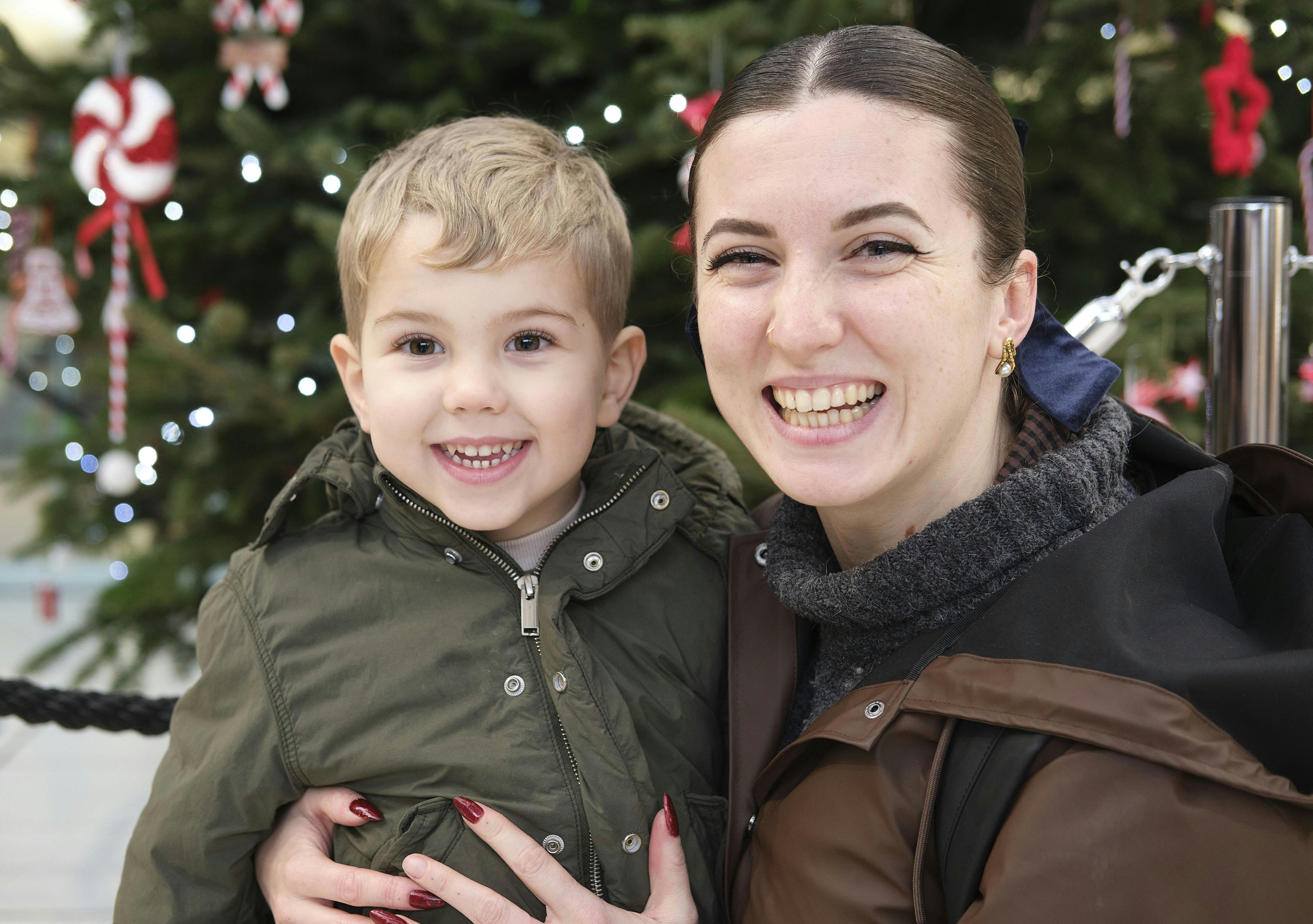A mum and toddler smiling at the photographer